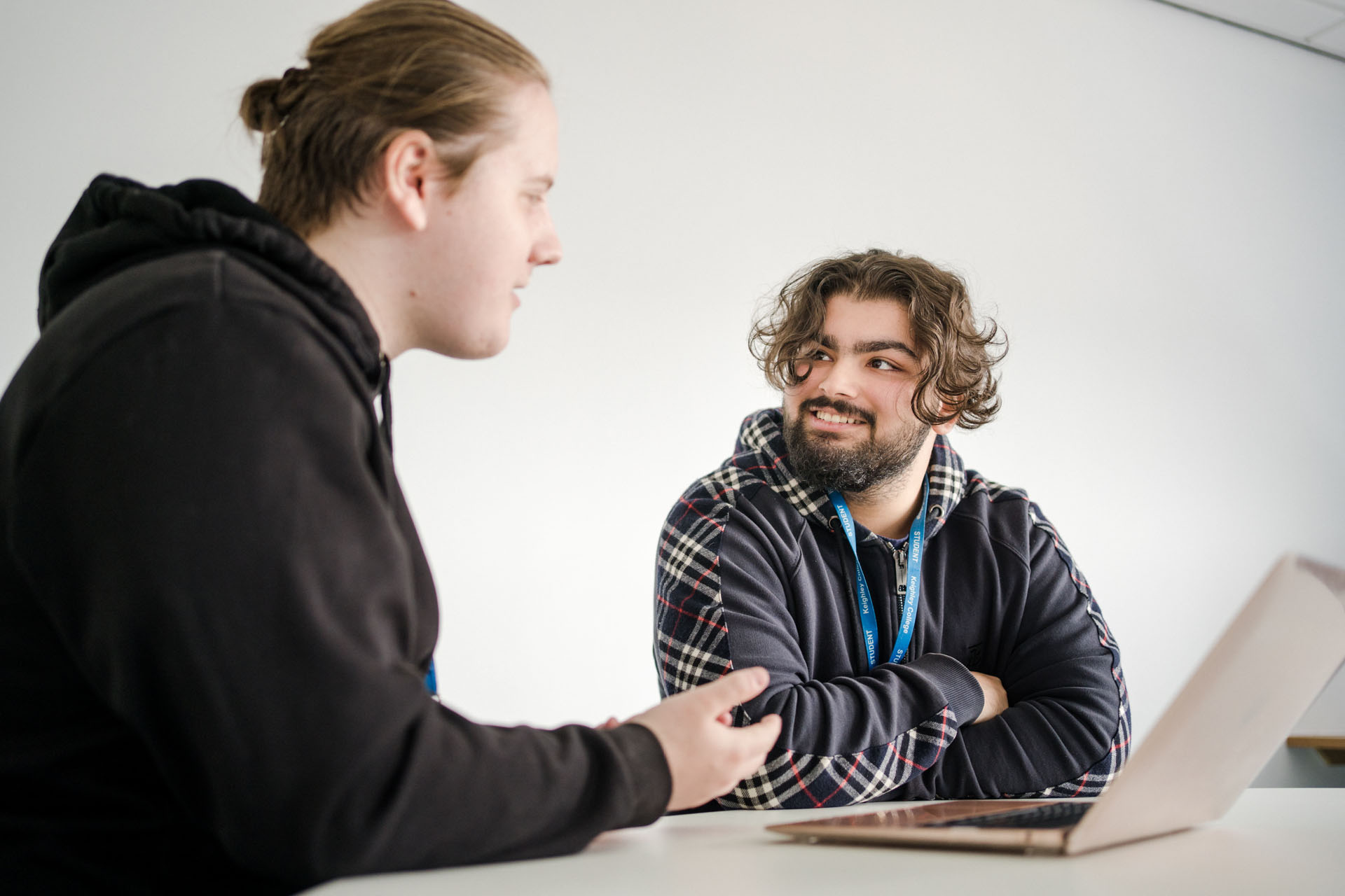 Two Keighley College students sat at their desk working together