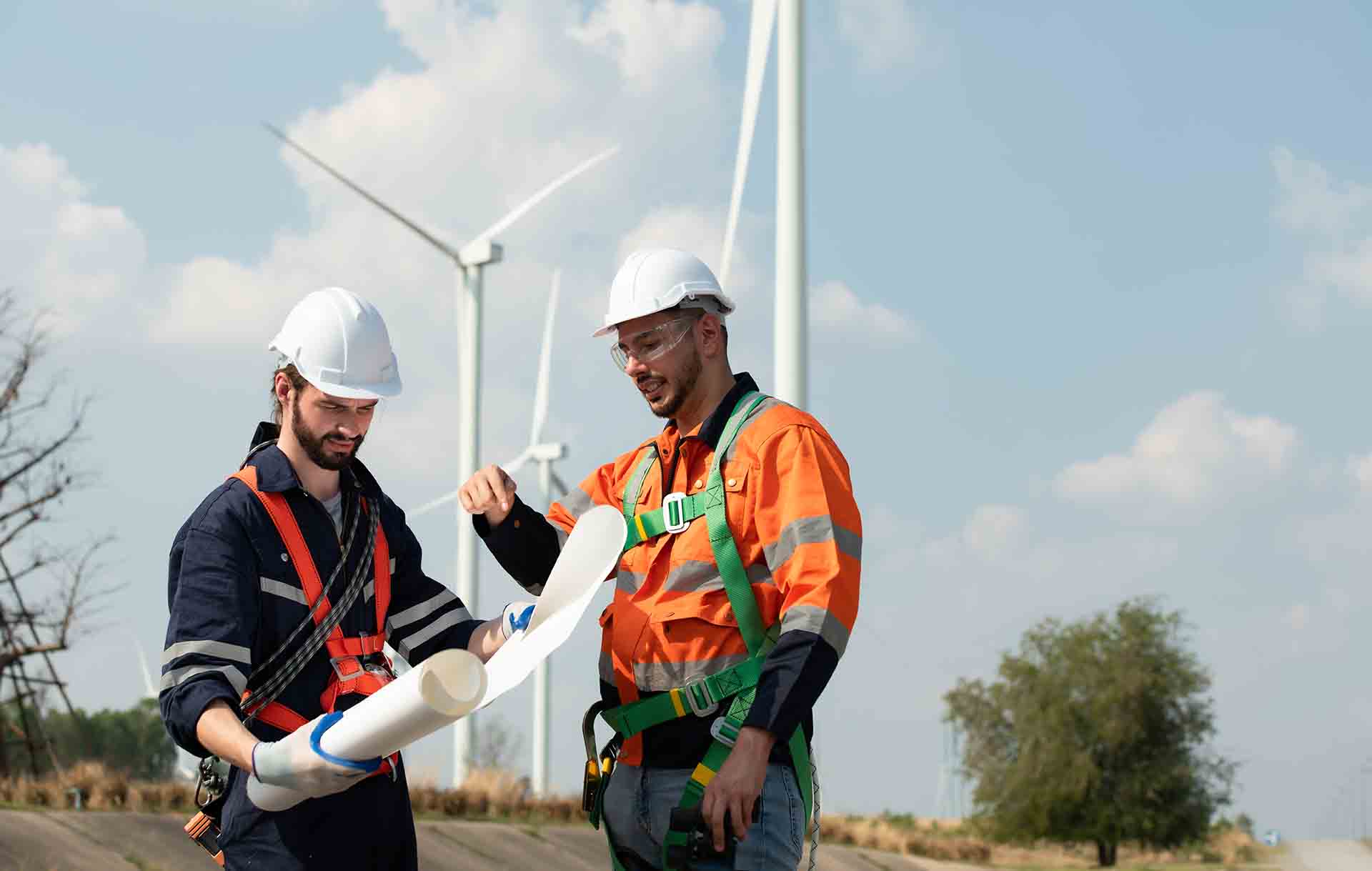 Surveyor and engineer Examine the efficiency of gigantic wind turbines that transform wind energy into electrical energy that is then used in daily life.