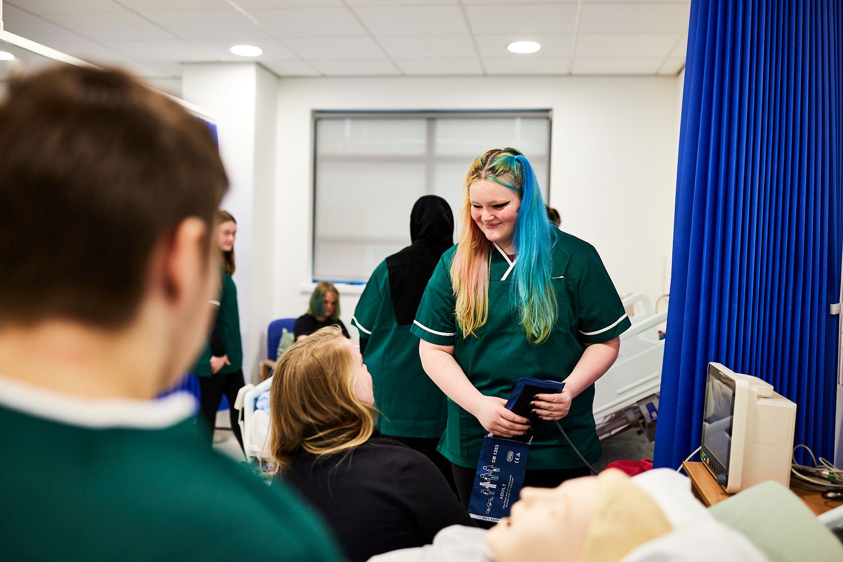 Student nurse checking the blood pressure of patients