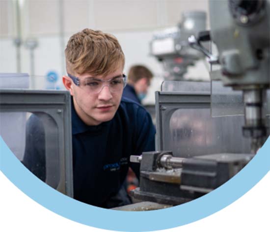 Keighley College apprentice wearing safety goggles using a pillar drill