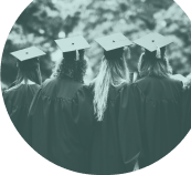 Black and white image of the back of female university graduates wearing caps and gowns