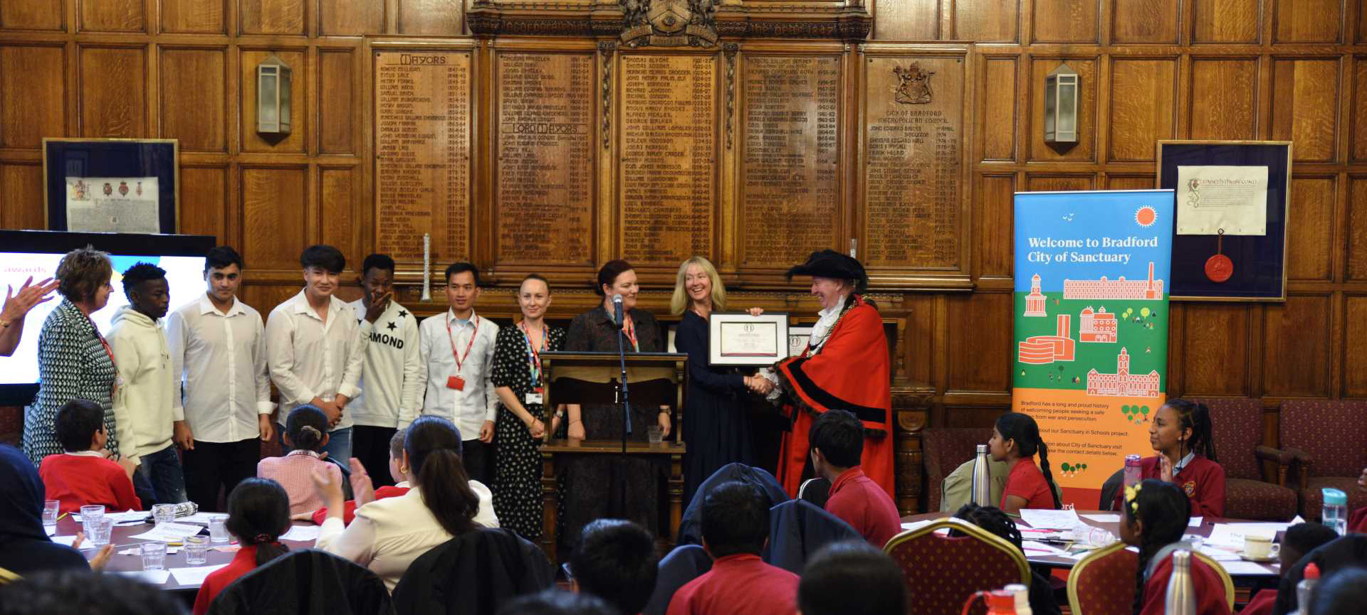 KC students and staff accepting an award for college of sanctuary